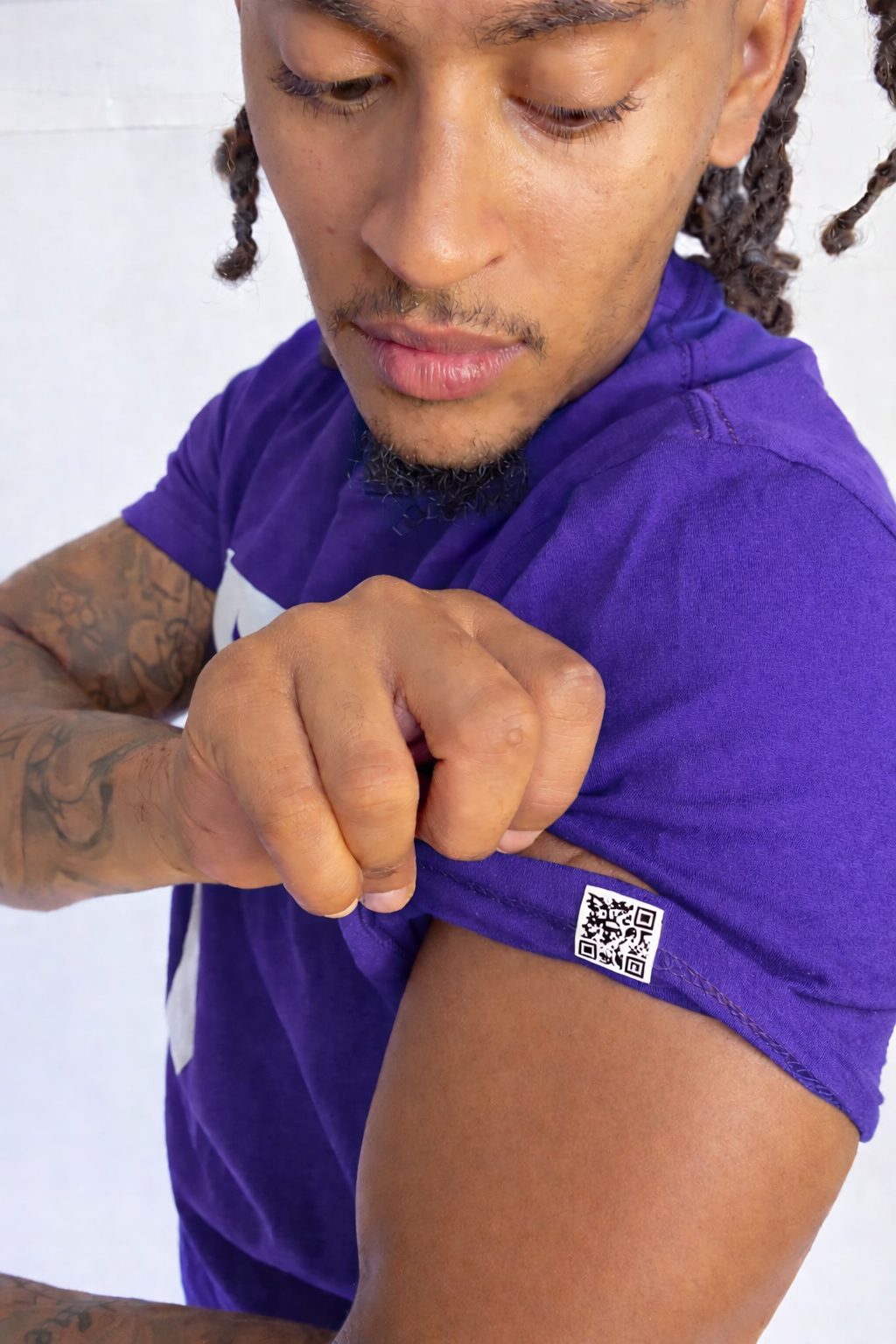 Model wearing a purple shirt with a QR code on a white background