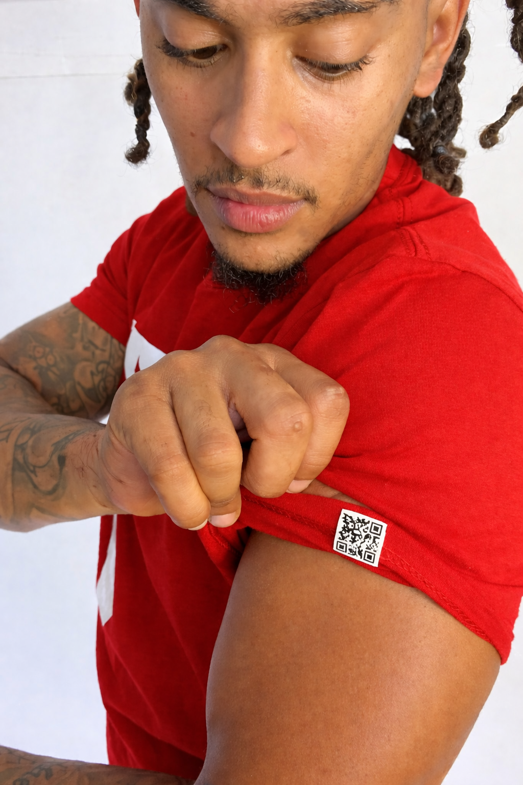 Model wearing a red shirt with a QR code on a white background