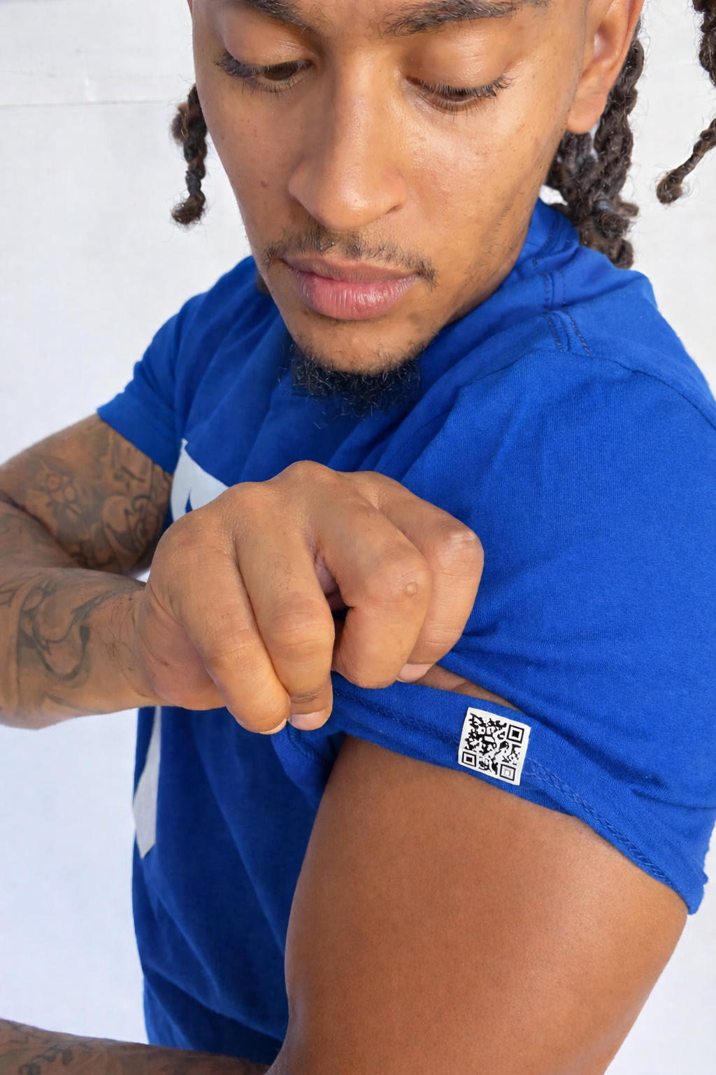 Model wearing a blue t-shirt with a QR code on a white background